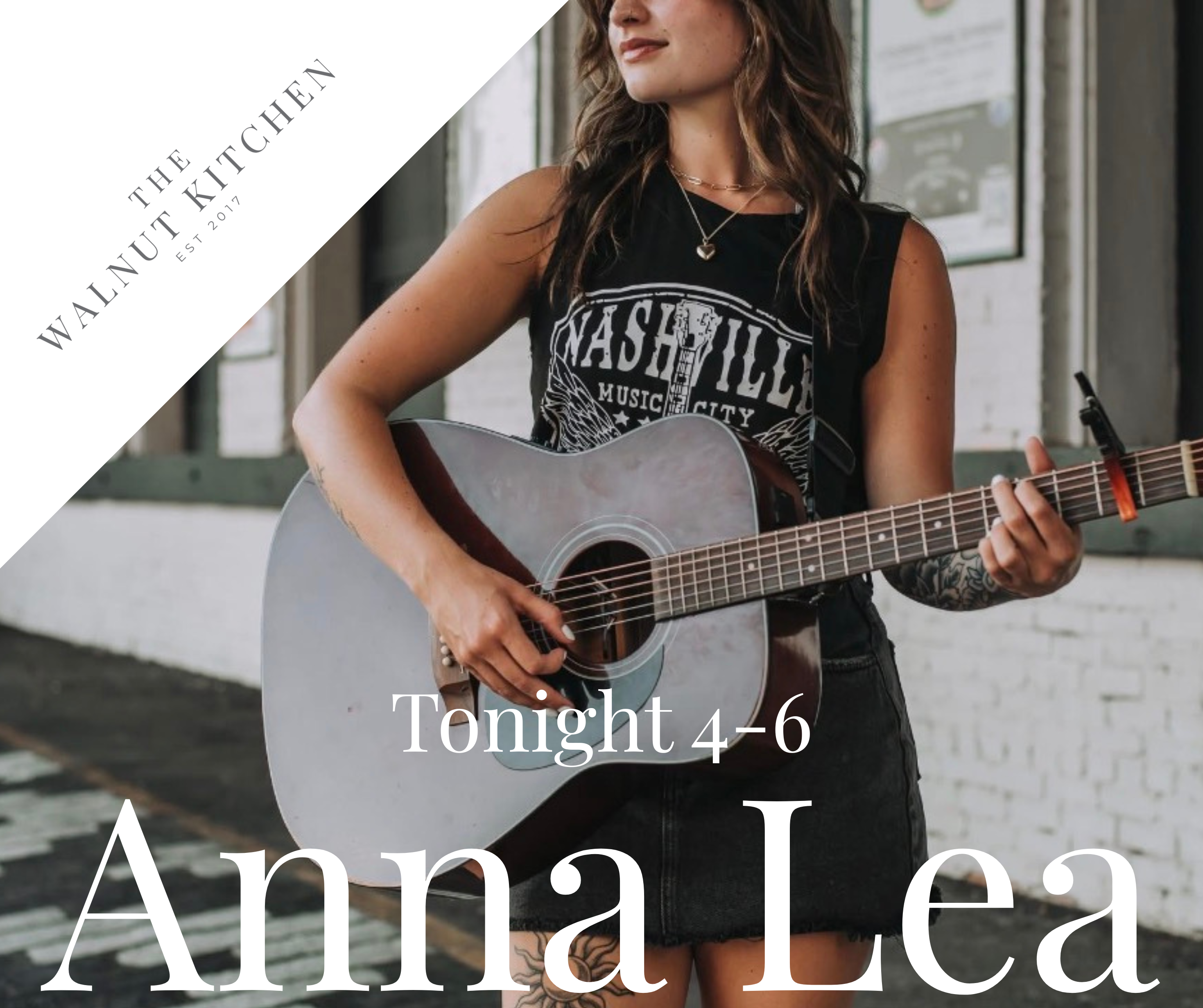 Plate with a pulled chicken sandwich on toasted bread and a side of crispy seasoned fries on a wooden table with blurred warm lights in the background.