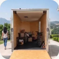 An open Flex storage trailer loaded with belongings in a driveway