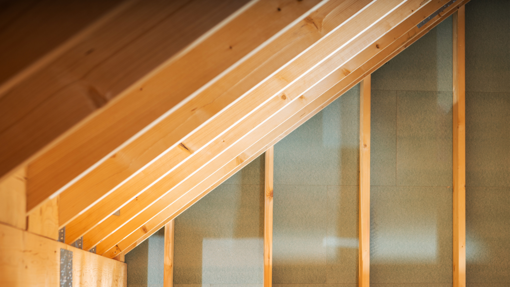A modern white building with curved balconies rises against a clear blue sky, showcasing sleek architecture and stylish design.