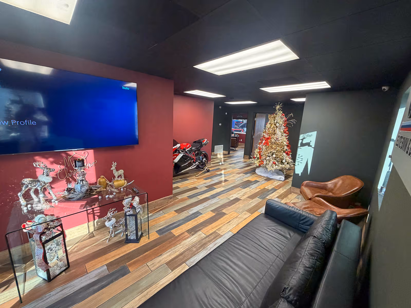 Customer lounge with leather seating and TV at EBB in Fontana