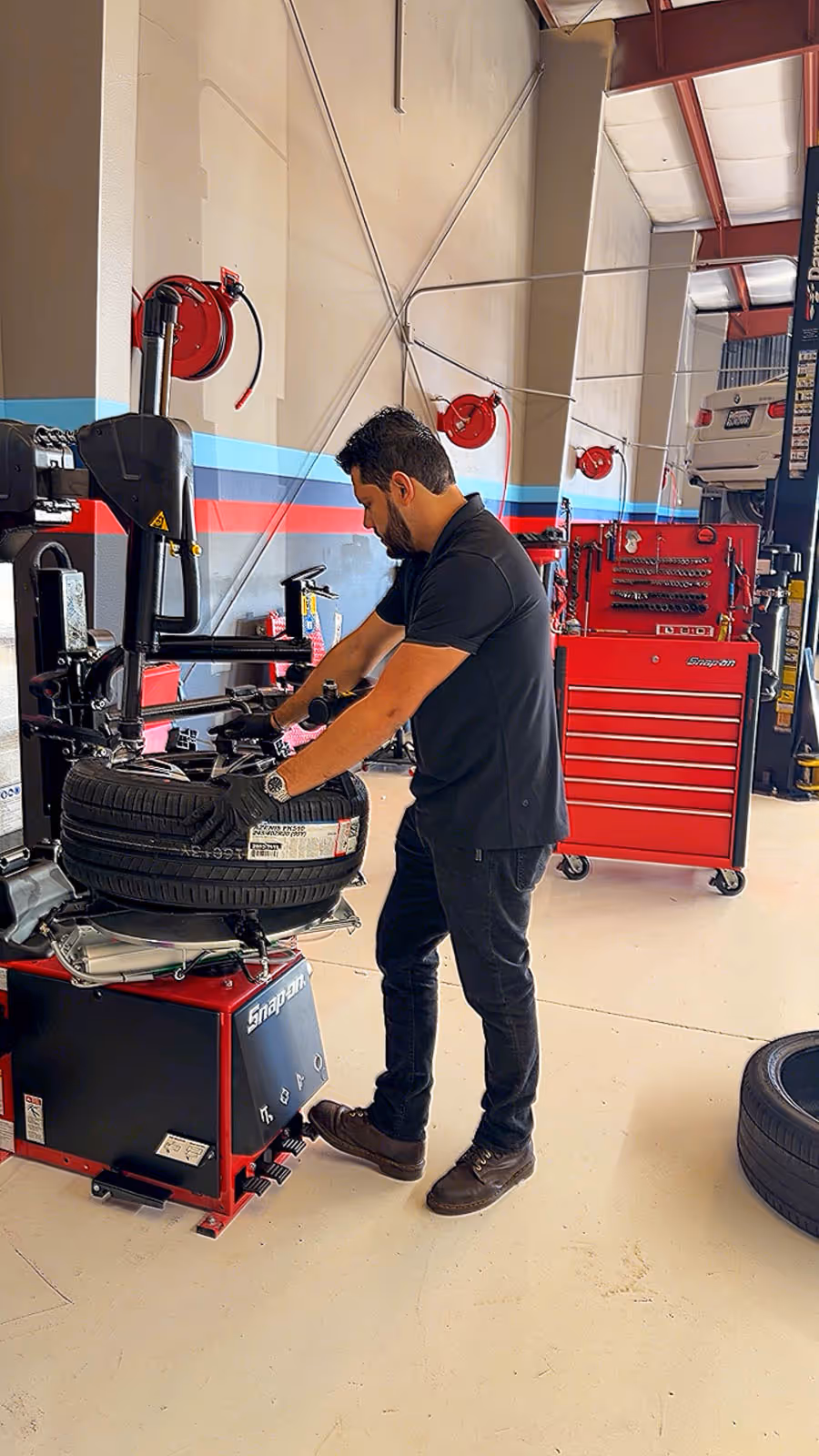 EBB technician mounting a tire on the tire machine