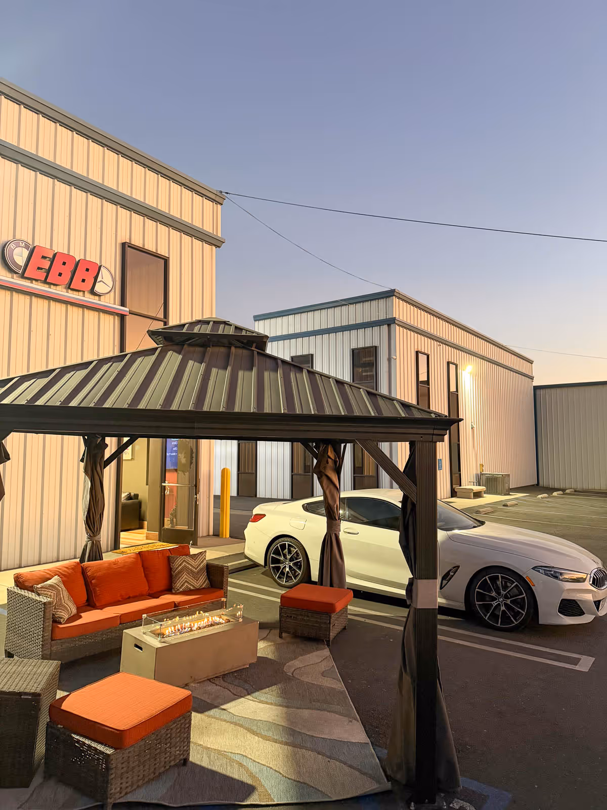 Covered patio with fire table outside the EBB shop