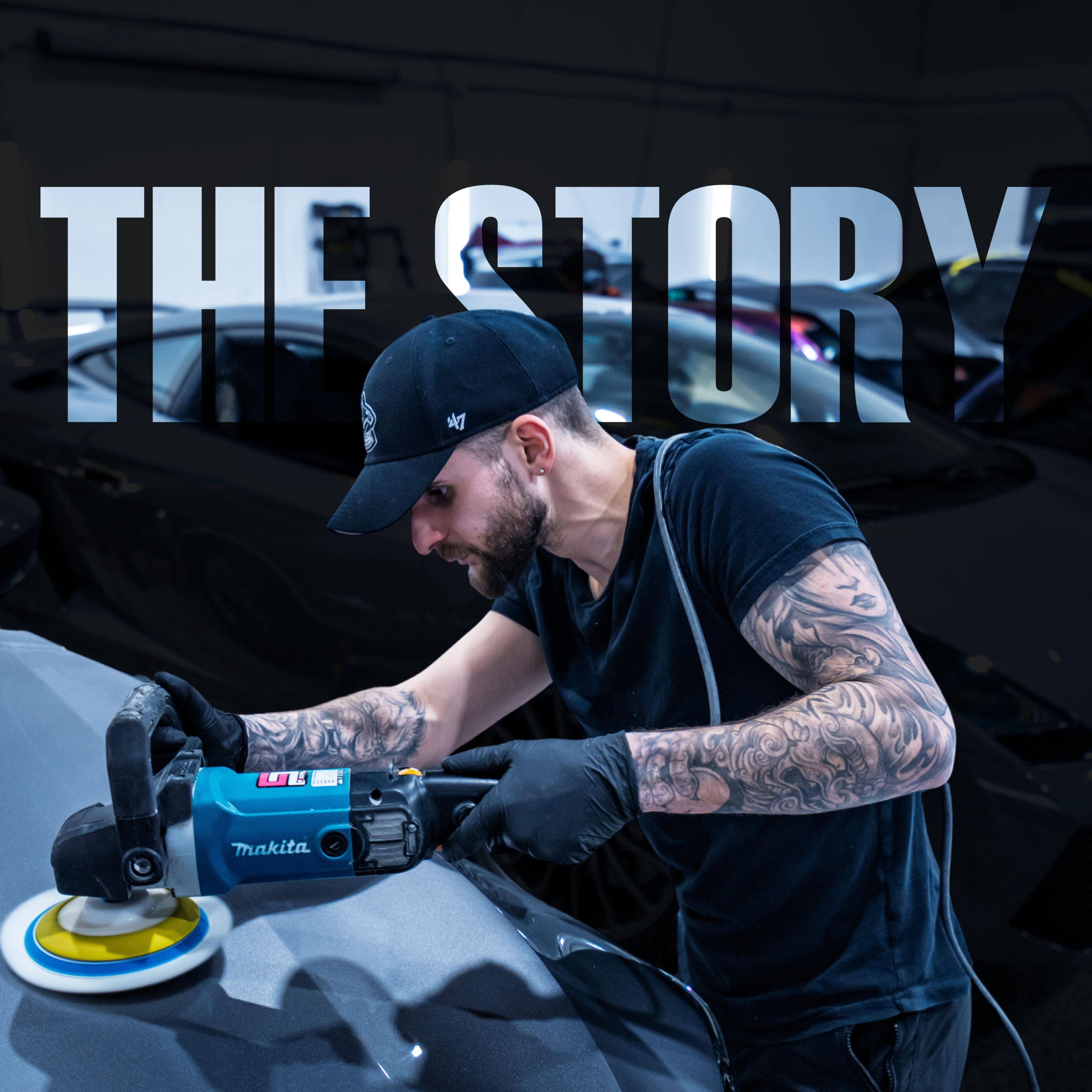 Tattooed man in black cap polishing car hood using a blue Makita power buffer.