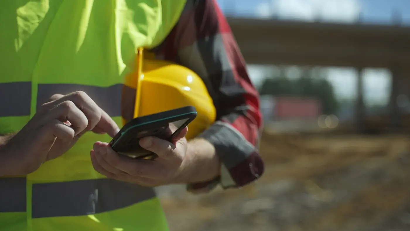 Project manager using a phone to keep homeowners updated during a remodel