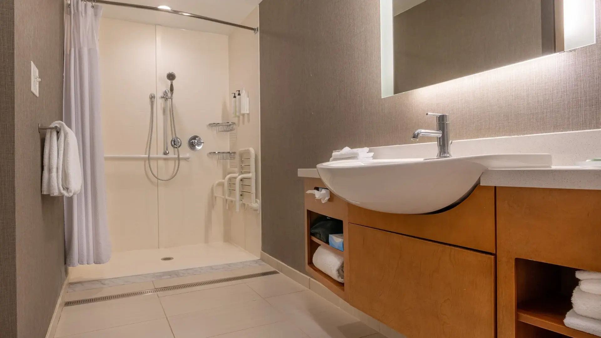 Accessible bathroom remodel with a curbless shower and grab bars