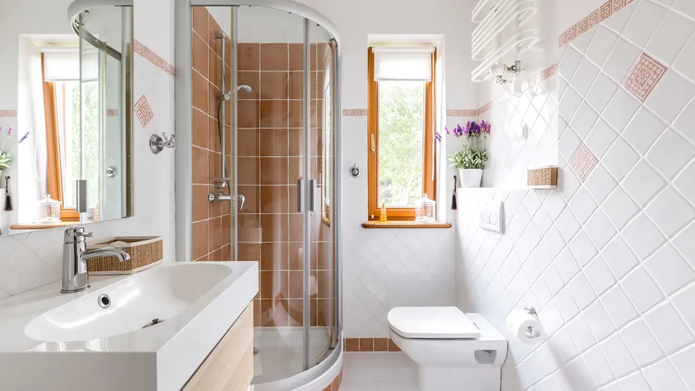 Small bathroom remodel using light finishes and a large mirror to feel bigger