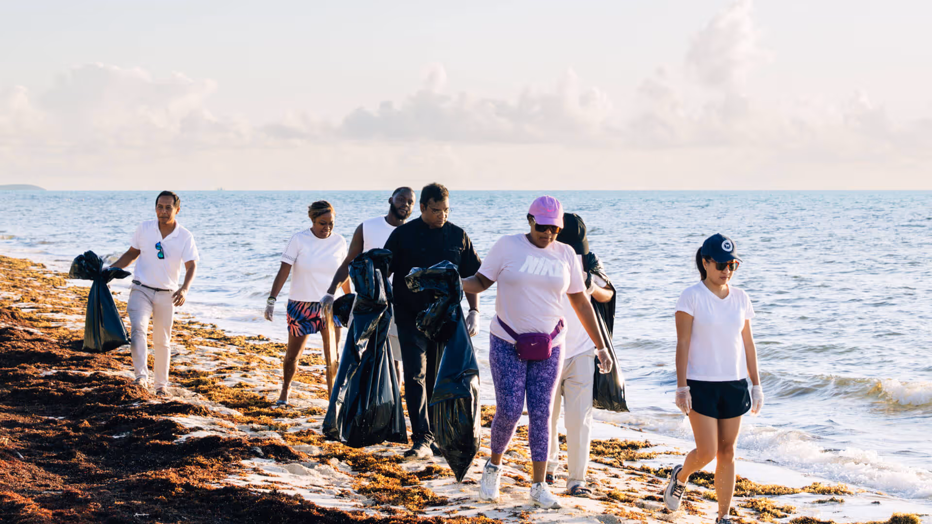 Island House LVM team members participating in a community beach cleanup in Turks and Caicos.
