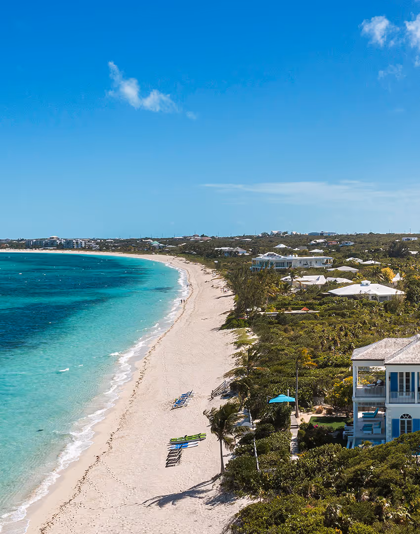 Two young local students in school uniforms sitting at a community school in the TCI.