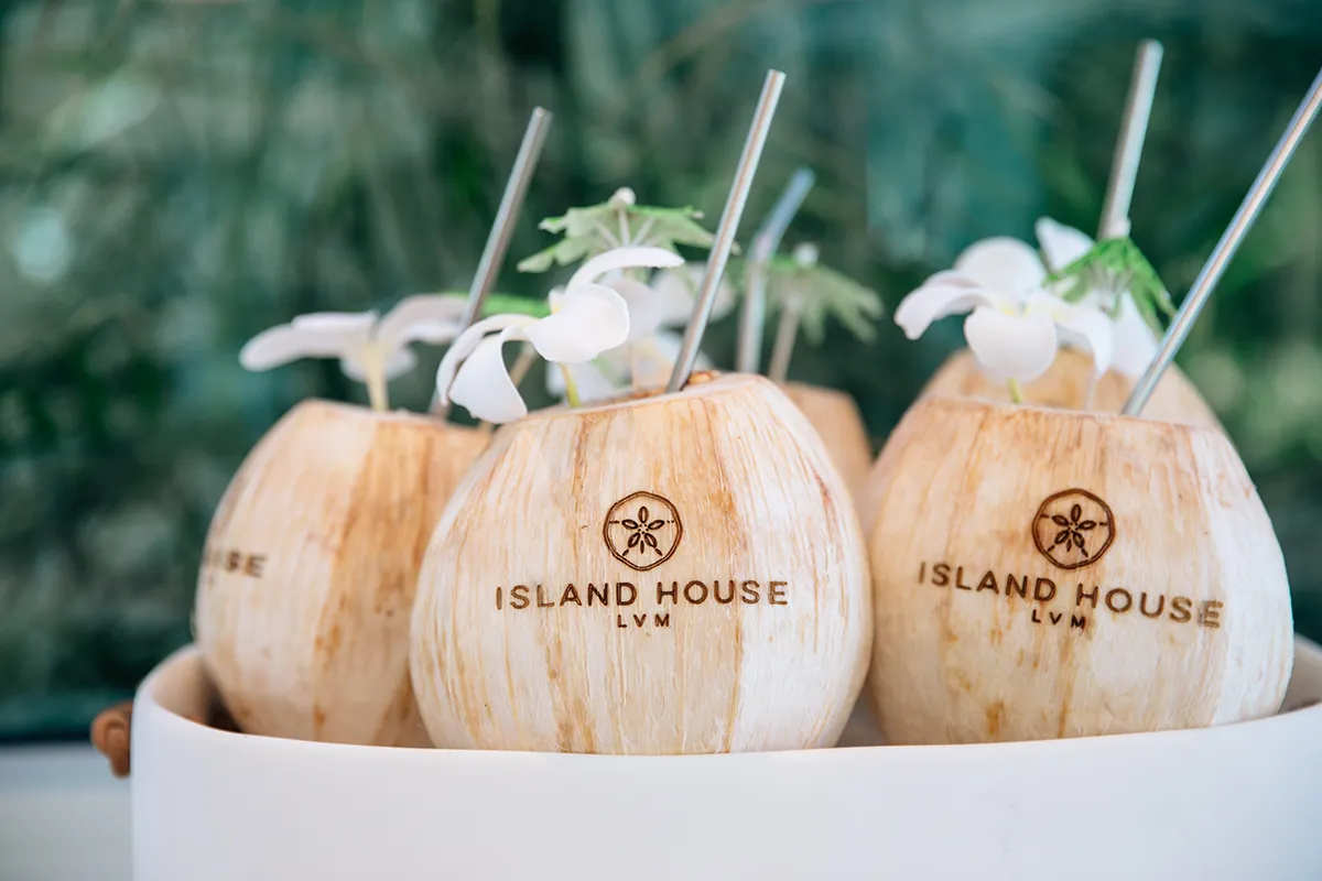 Two young local students in school uniforms sitting at a community school in the TCI.
