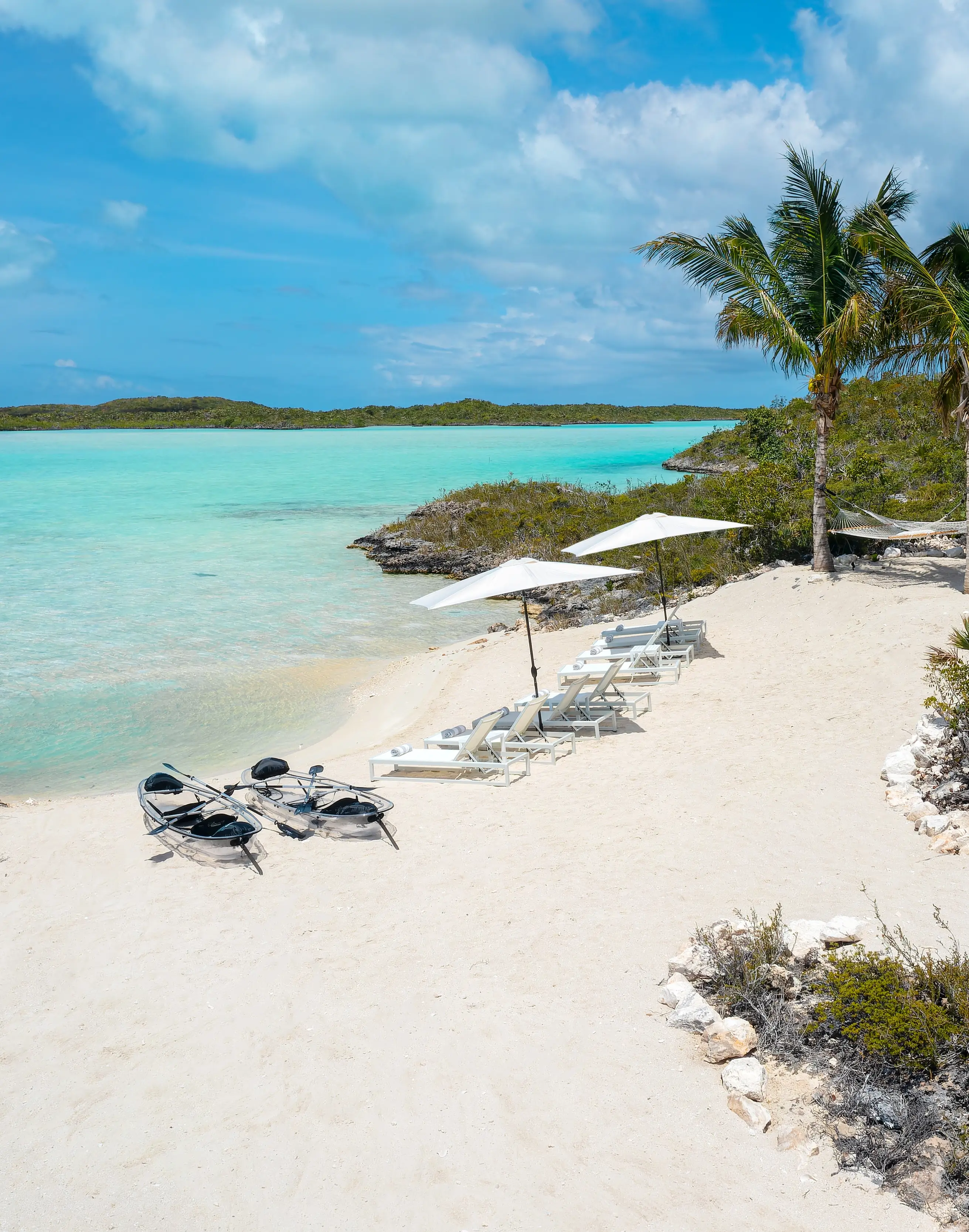 Two young local students in school uniforms sitting at a community school in the TCI.