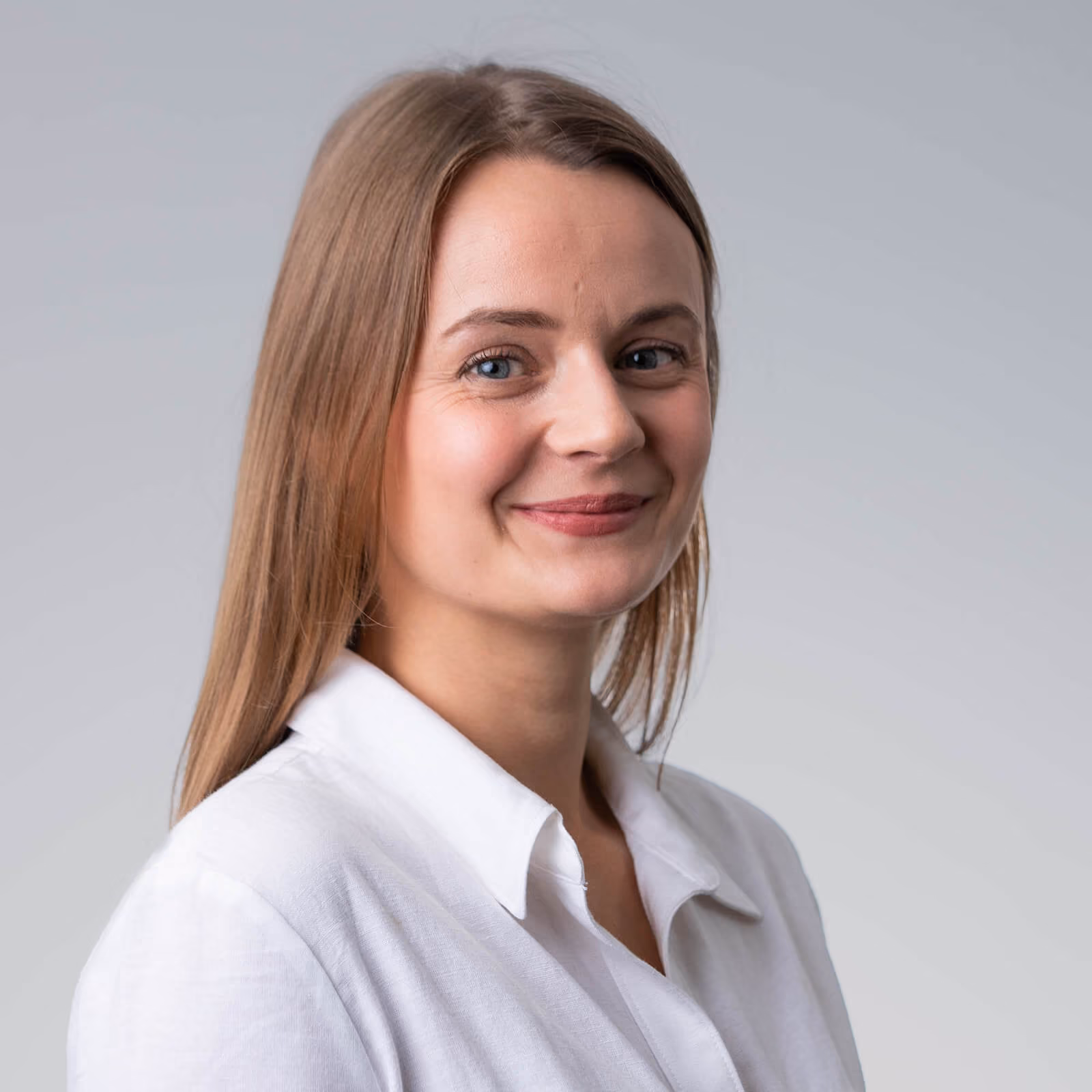 Professional studio headshot of a smiling woman in a white shirt — headshot photography by AlTopping.com