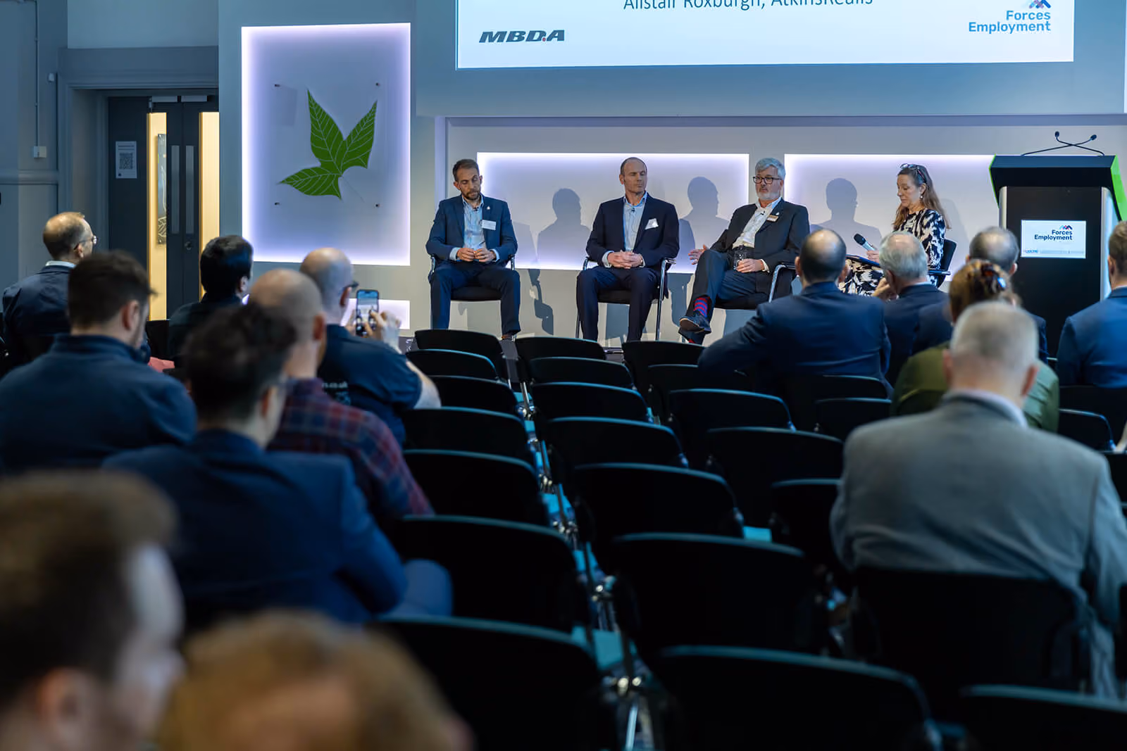 Panel of four speakers on stage at the Forces Employment Charity defence and security conference — by AlTopping.com