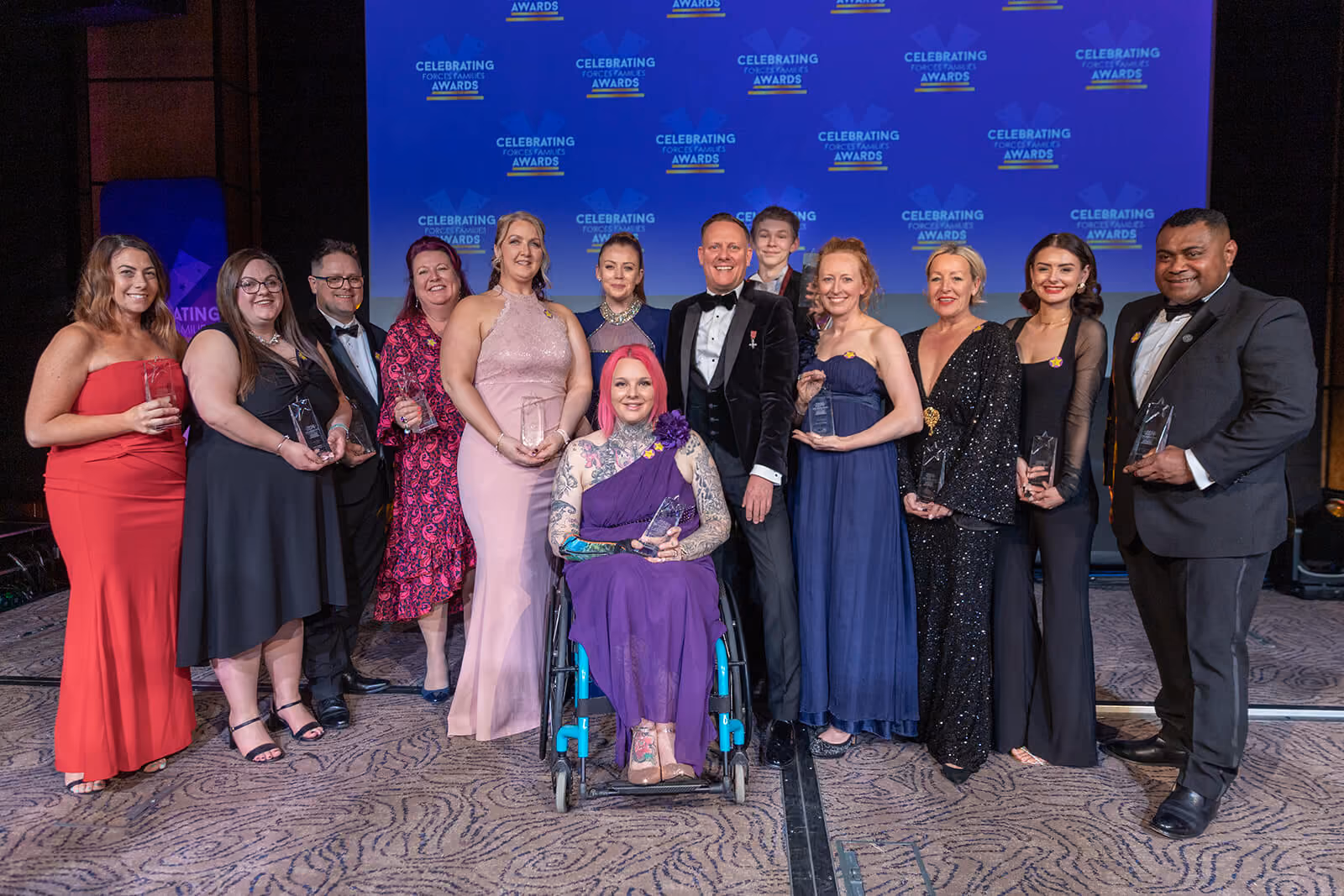 Award winners gathered on stage at the Celebrating Forces Families Awards — event photography by AlTopping.com