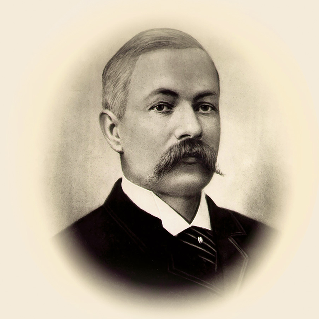 Black and white portrait of Melville Bissell wearing a dark suit and tie.