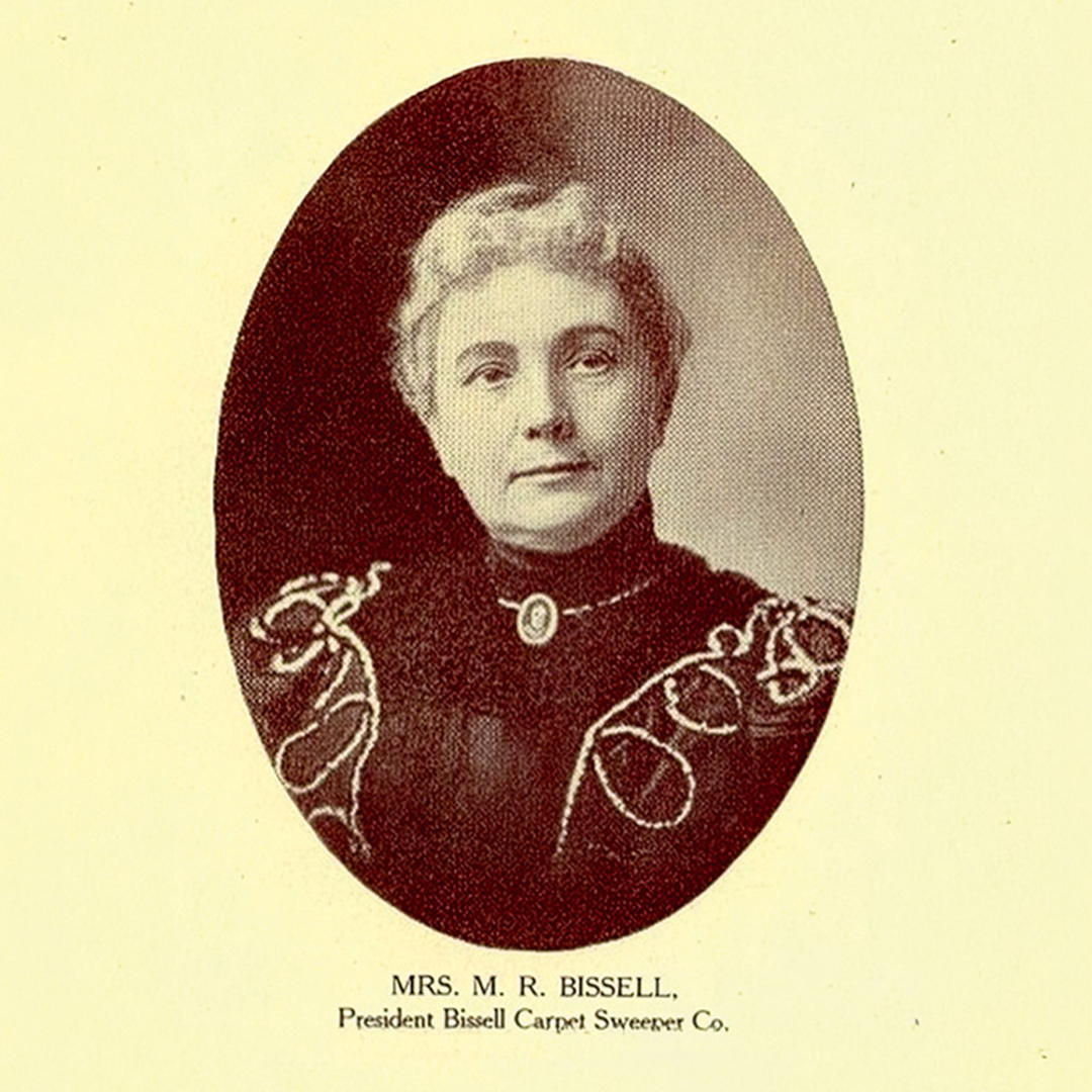 Vintage portrait of Anna Bissell wearing a dark dress with decorative embroidery.