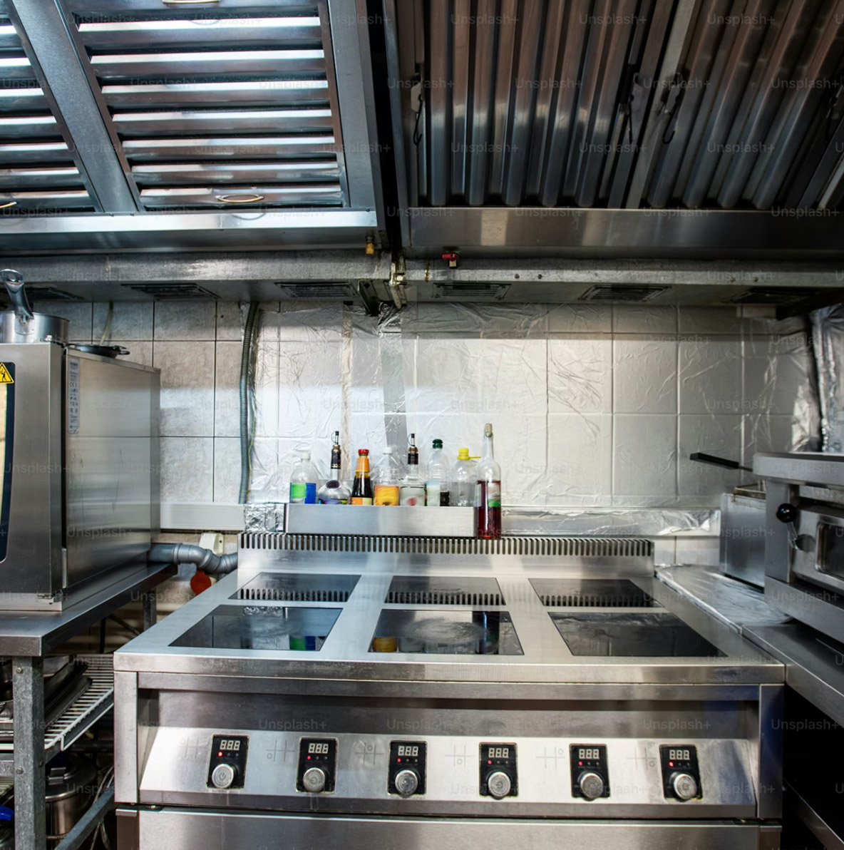 Commercial refrigeration technician servicing a walk-in cooler inside a commercial kitchen.