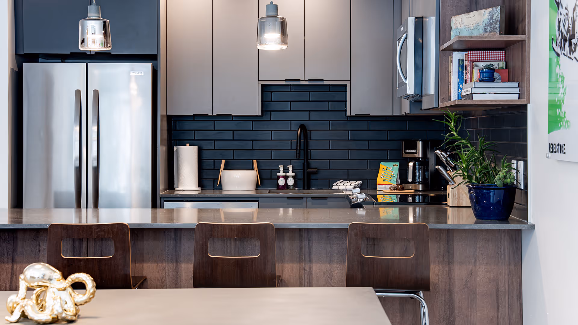 Clean bedroom, with side tables, lamps, made bed with yellow and blue pillows
