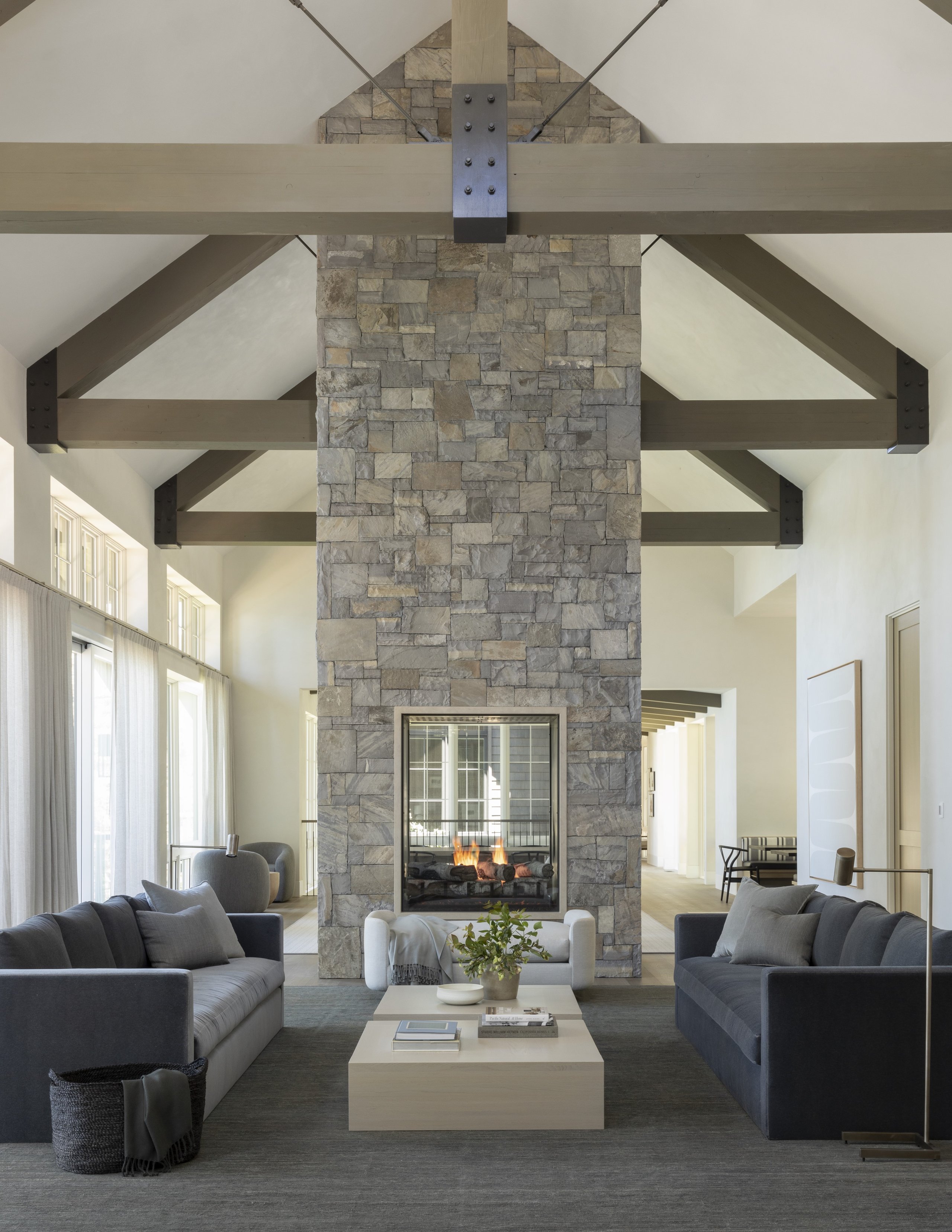 View of living space with timbers, high ceilings, and fine finished walls