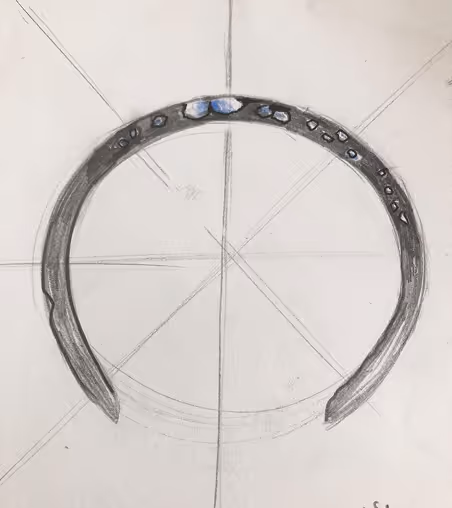 Hand-drawn sketch of a circular bracelet with small stones, centered on grid lines on paper.