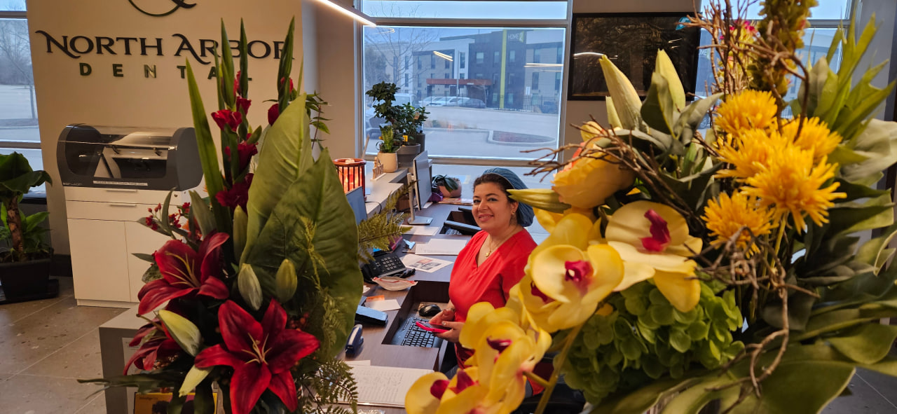 Reception desk and floral arrangements at North Arbor Dental in Kitchener.