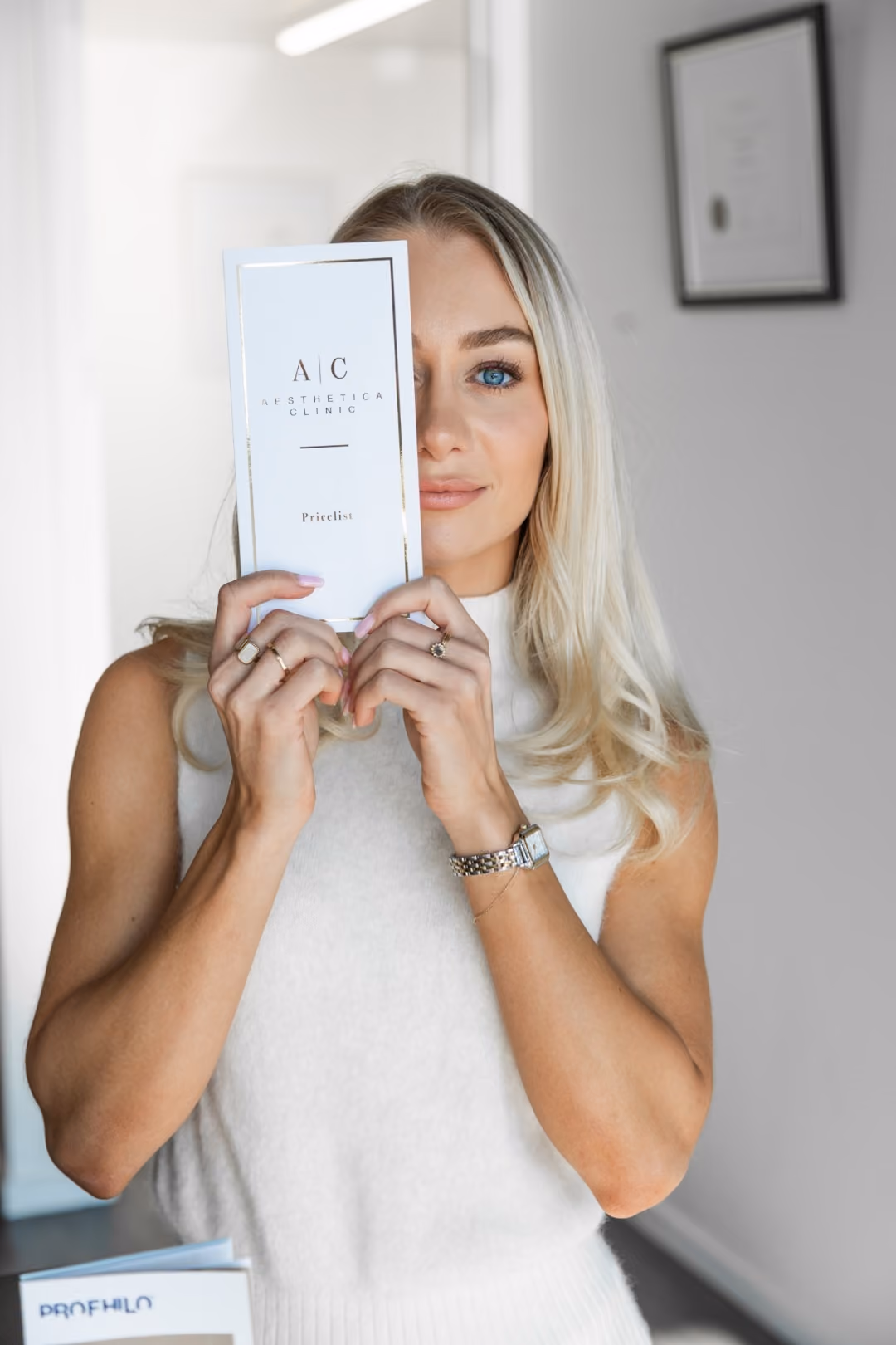 Woman holding the Aesthetica Clinic price list