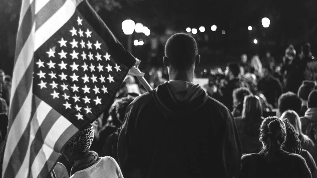 An American flag above a crowd in Freedom Forum’s Future Freedom Fighters campaign.