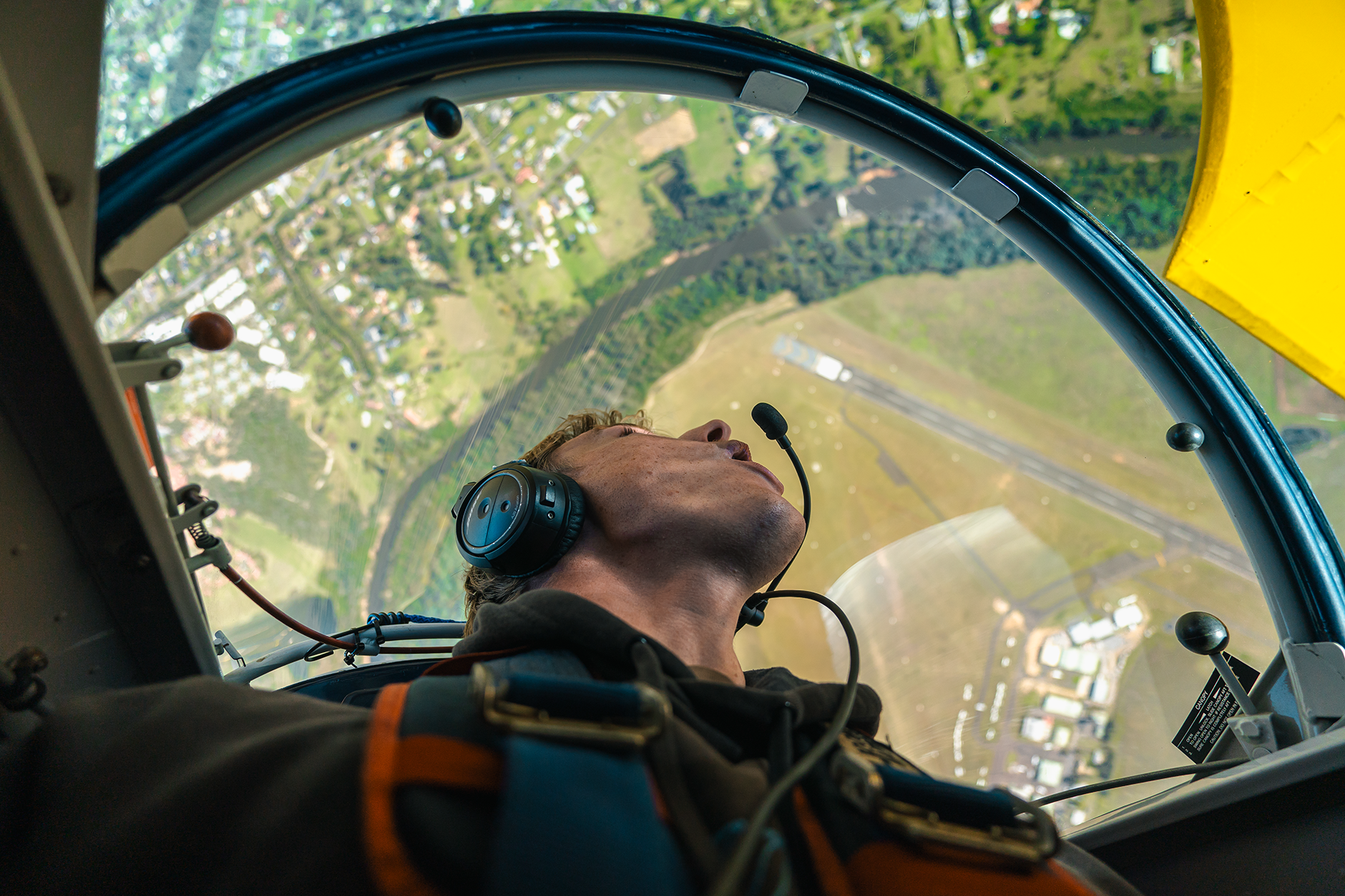 airplane passenger looking at the earth below his cockpit