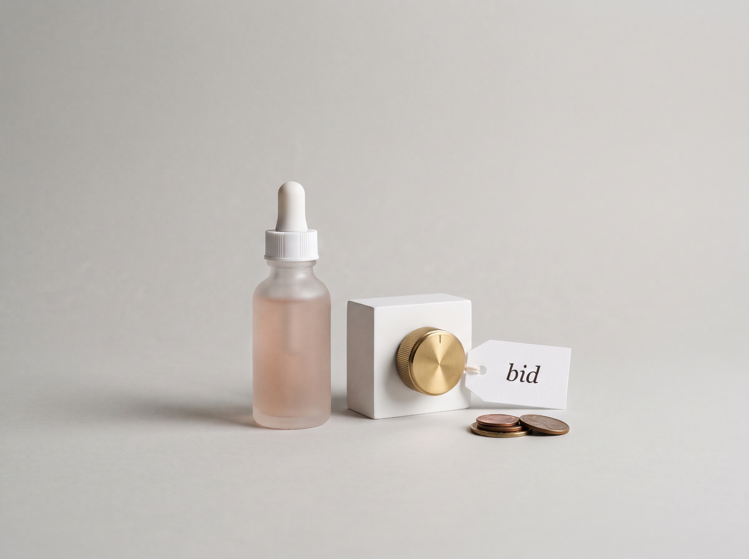 Frosted skincare serum bottle beside a brass control dial tagged bid, with a few coins