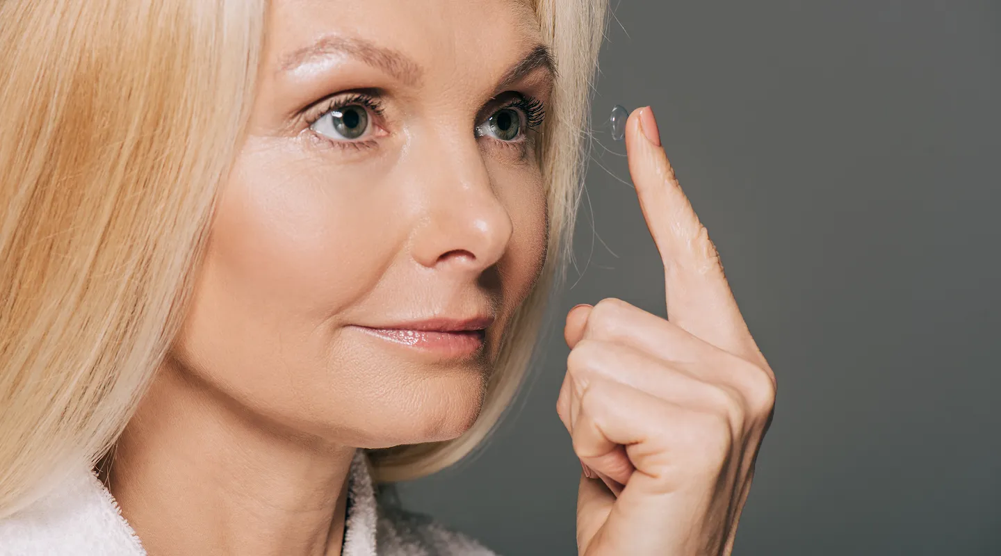Woman holding soft contact lens demonstrating proper contact lens application technique