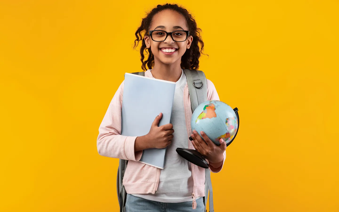 Happy student wearing children's prescription glasses ready for back-to-school with clear vision