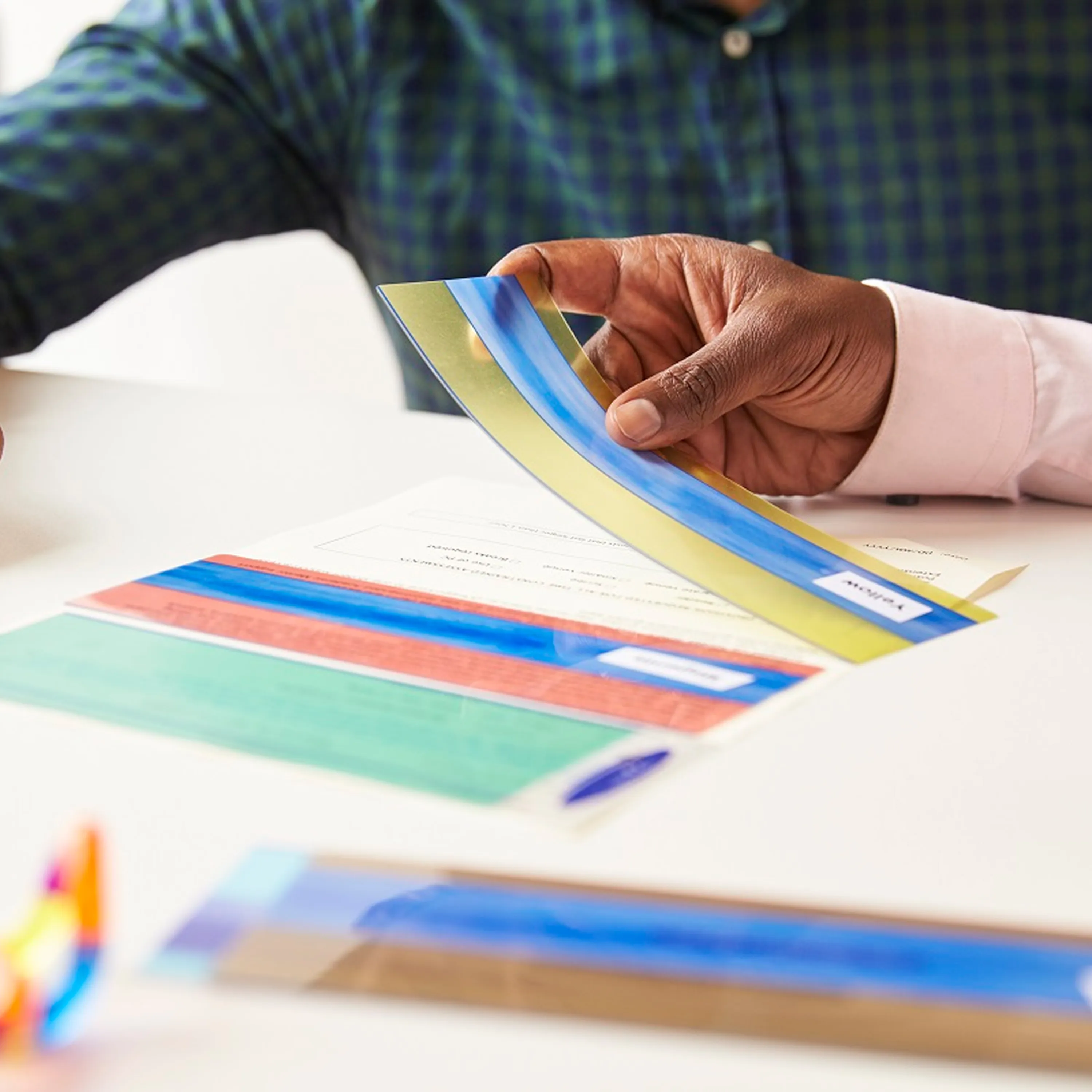 Professional colorimetry consultation with colored filter samples for visual stress assessment