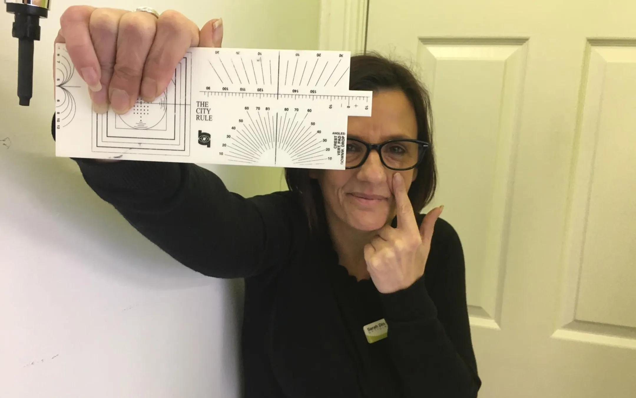 Optometrist demonstrating vision testing procedure with professional eye examination chart