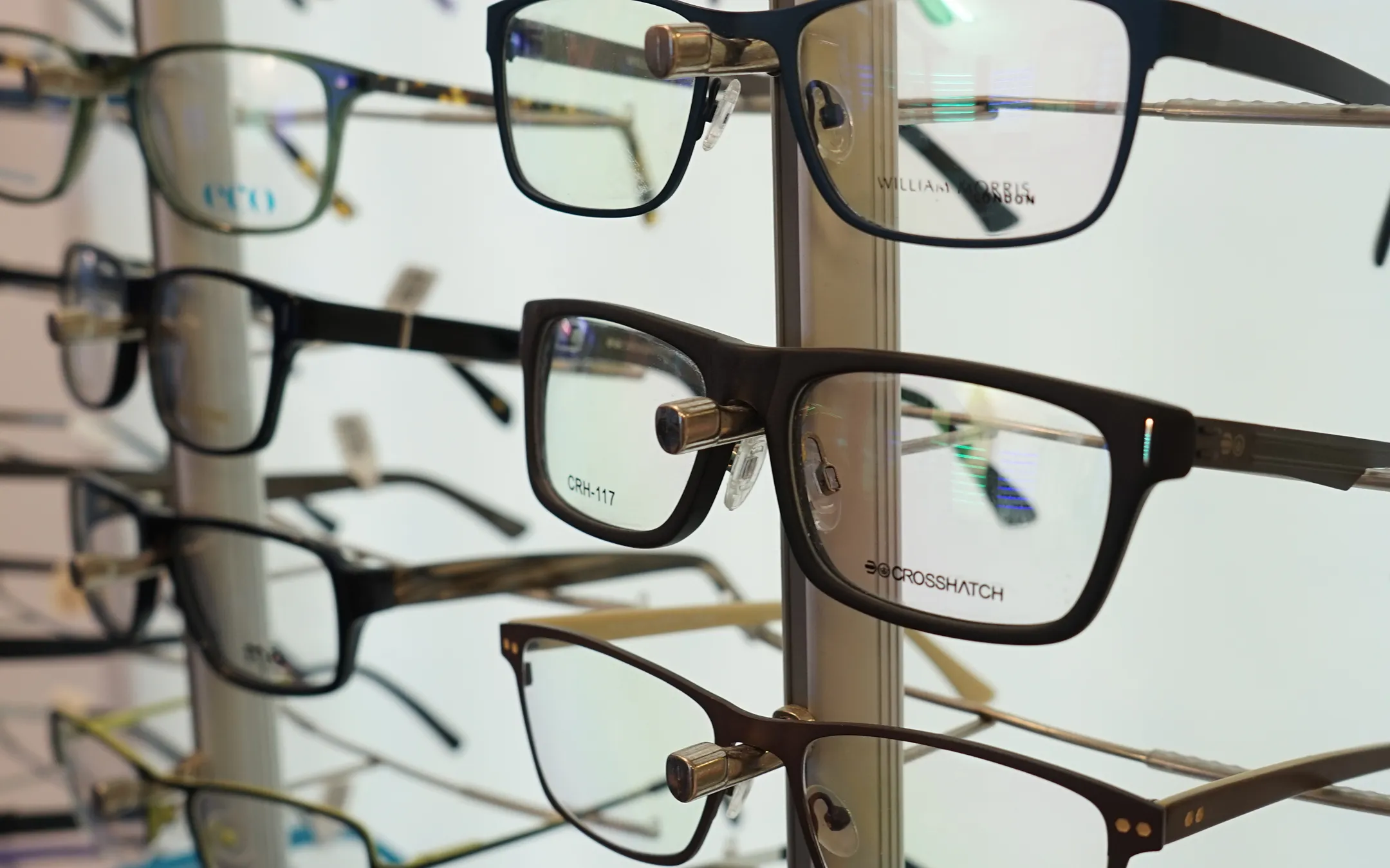 Designer eyeglasses frames display featuring William Morris and Crosshatch prescription glasses