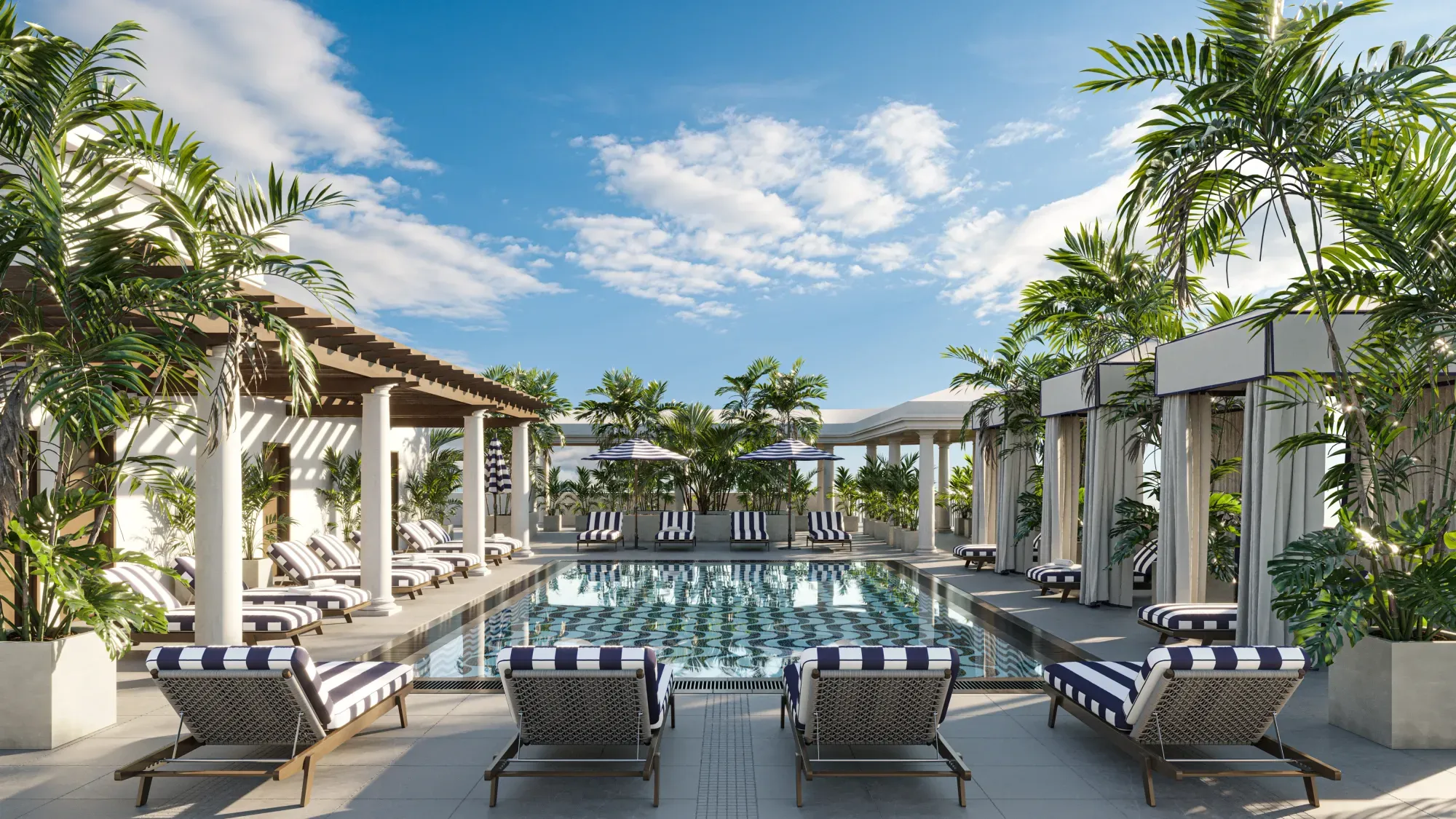 The rooftop pool at The Avenue, striped cabanas under palm trees