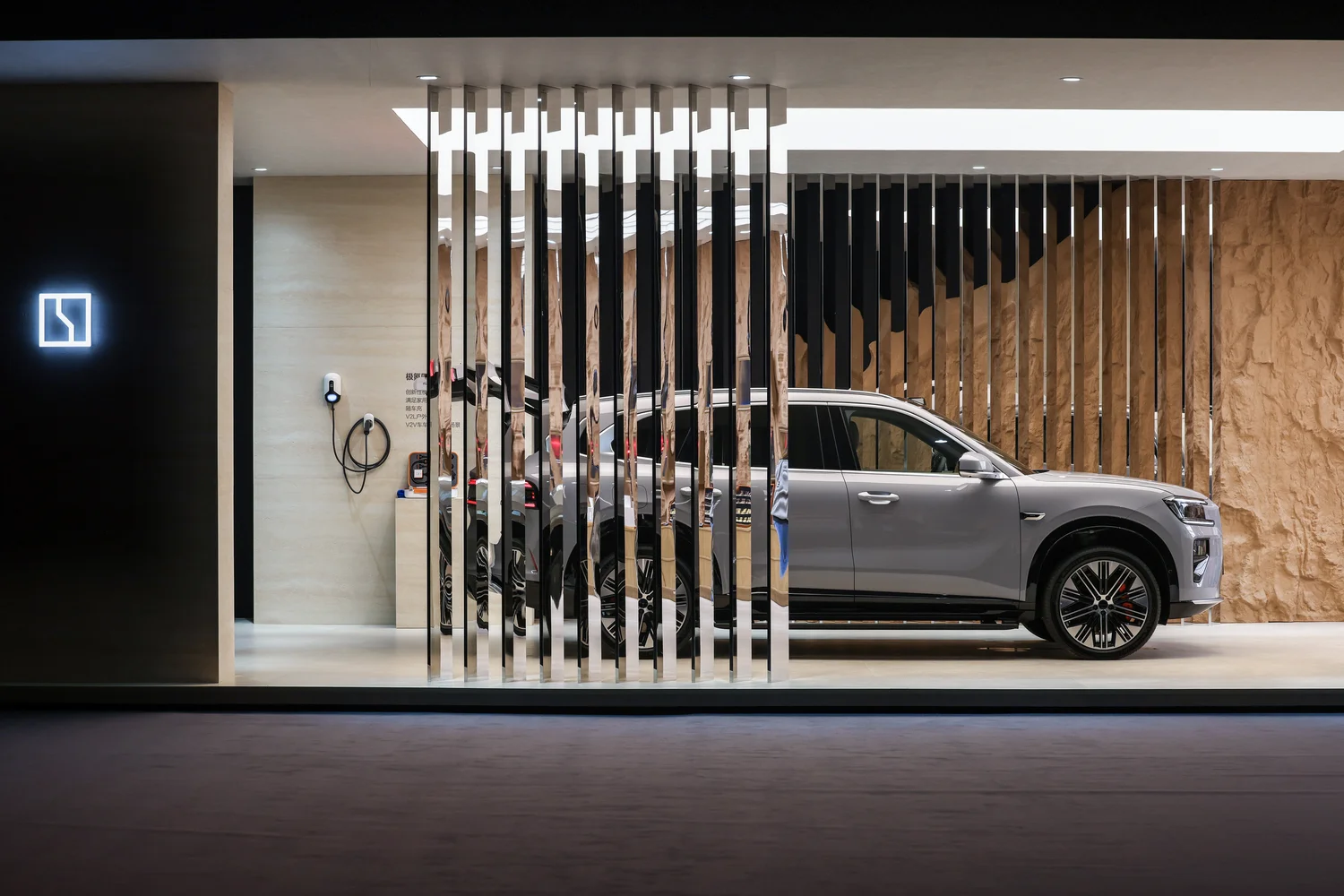 ZEEKR 8X booth design with reflective vertical fins echoing the vehicle's front grille design language