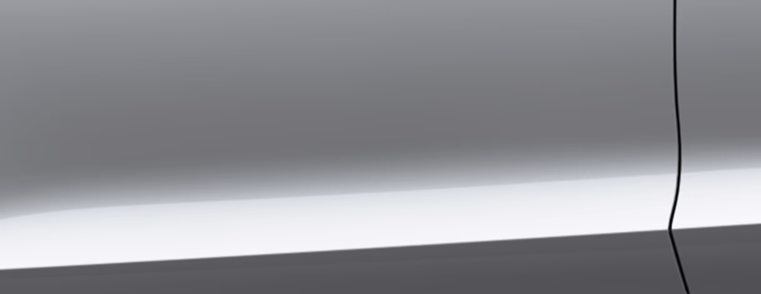 Eine minimalistische Detailaufnahme zeigt einen Ausschnitt der Karosserie des Škoda Fabia Balance in der Lackierung Moon-Weiß Perleffekt. 
