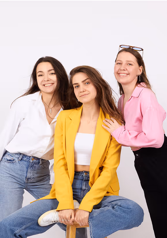 Smiling women posing together in studio