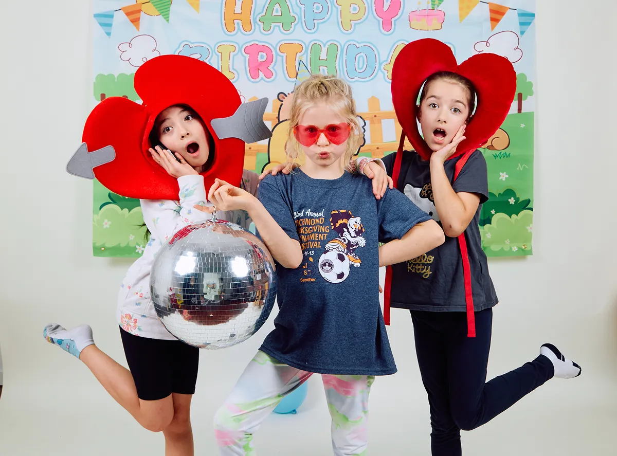 Kids wearing colourful party props in the Click Click self-portrait studio