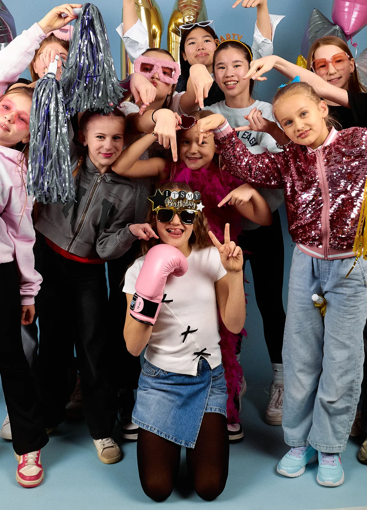 Group of kids celebrating with props and a disco ball at Click Click Vancouver