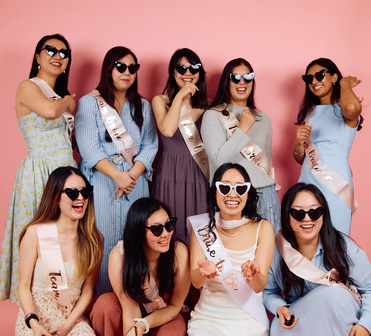 Bachelorette party group posing with sunglasses and sashes at Click Click studio