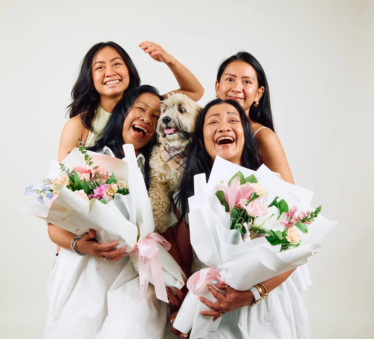 Group self-portrait with a dog and flowers at Click Click studio in Vancouver