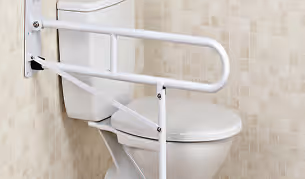 Toilet with a white grab rail installed on the wall for accessibility support.