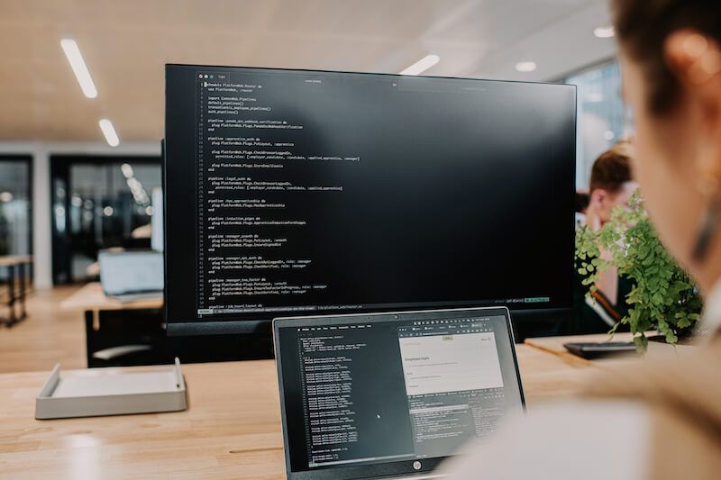 people sitting at desks and working on computers