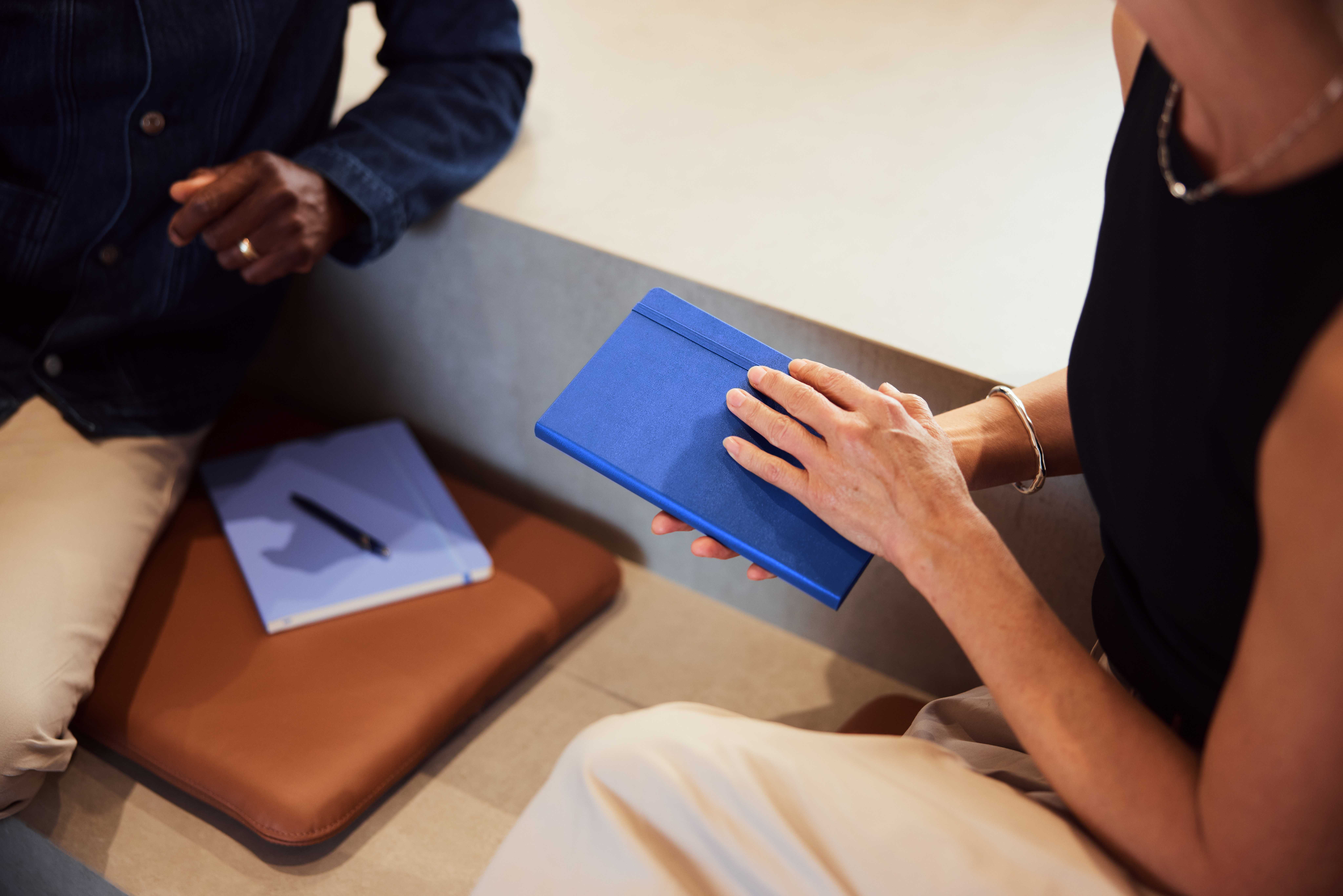 an image showing two learners with notebooks