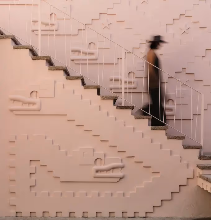 Sophisticated and arty atmosphere featuring an architectural staircase at La Valise San Miguel, with a female silhouette walking up.