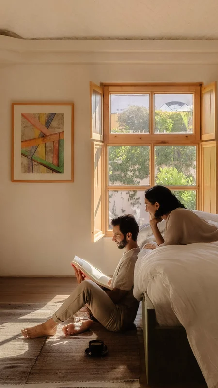 Silhouette of a couple amidst architectural light and shadows at La Valise San Miguel Hotel.