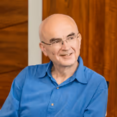 Dr Richard Cave smiling at the camera 