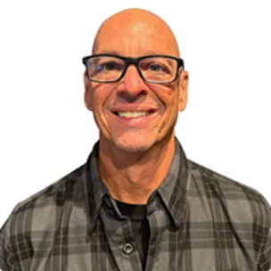 Portrait of a smiling man wearing glasses and a plaid shirt