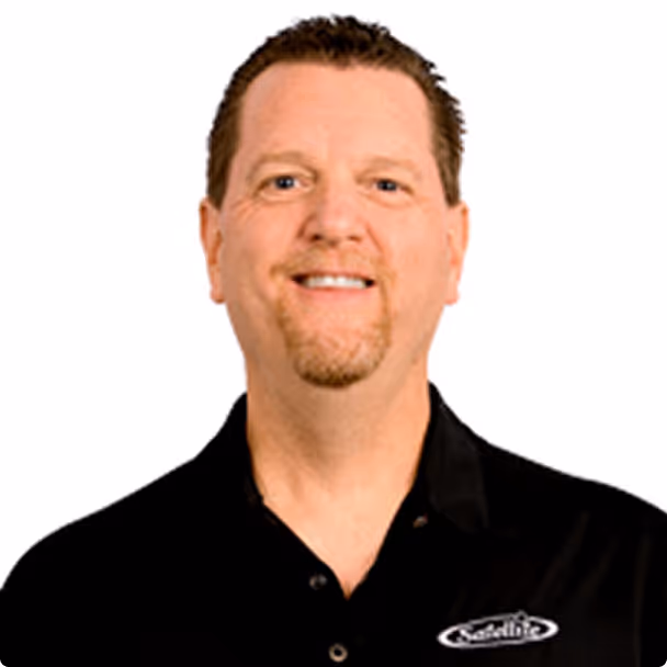 Man wearing black Satellite Industries polo shirt on white background