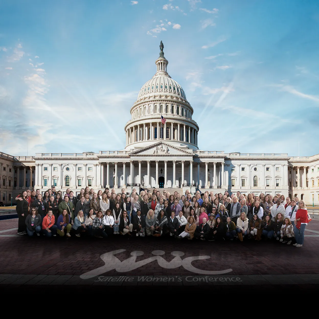 Large group of women posing in front of the U.S. Capitol building outdoors